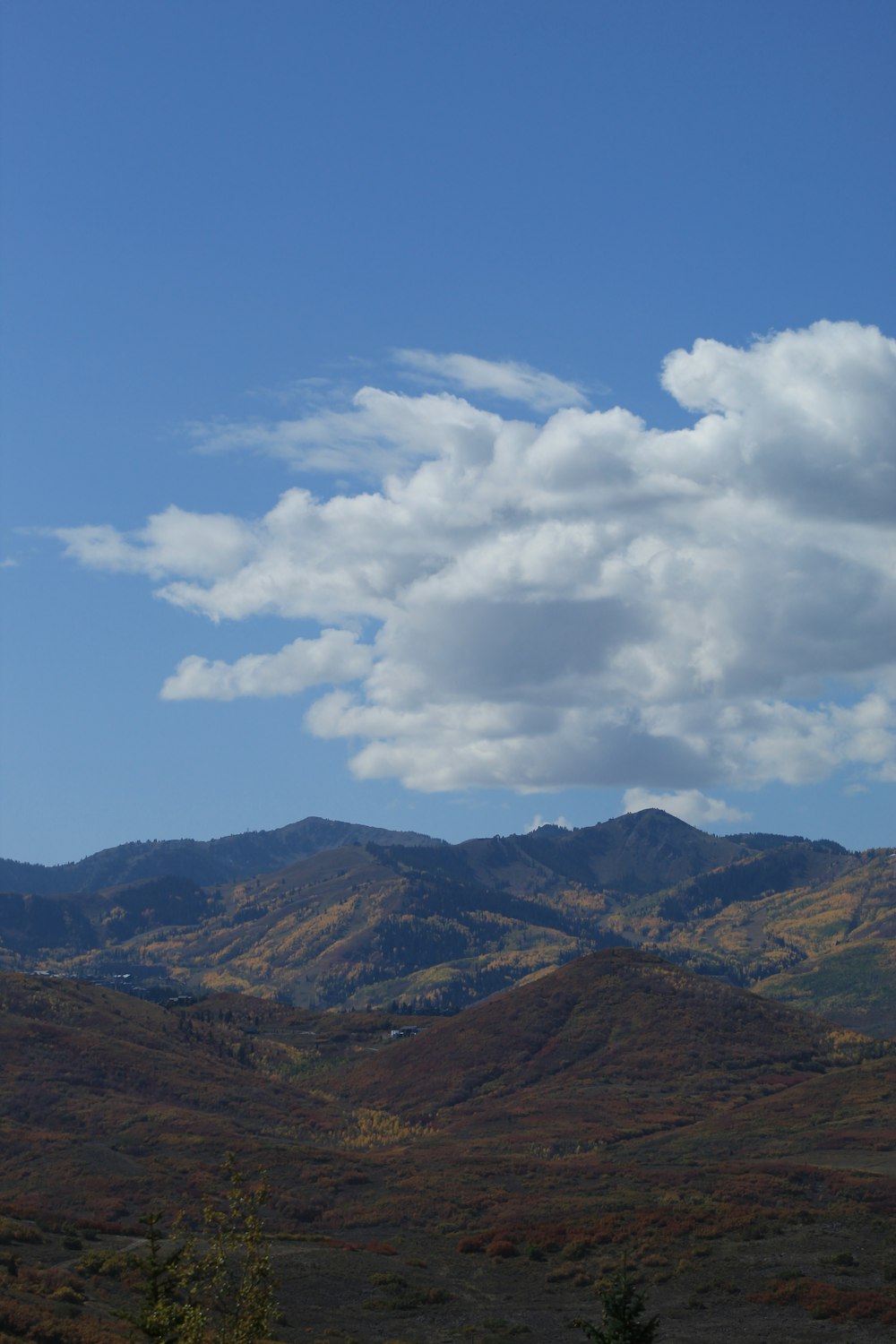 a view of a mountain range with clouds in the sky