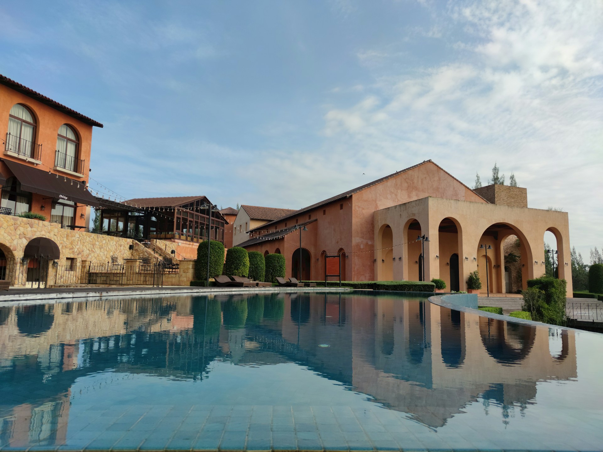 woman wearing yellow long-sleeved dress under white clouds and blue sky during daytime
