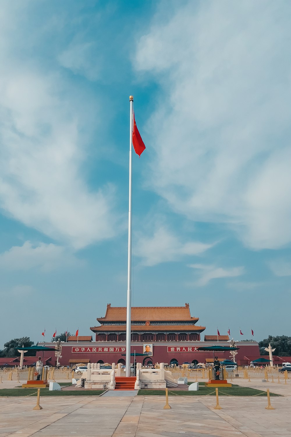 a tall flag pole in front of a building