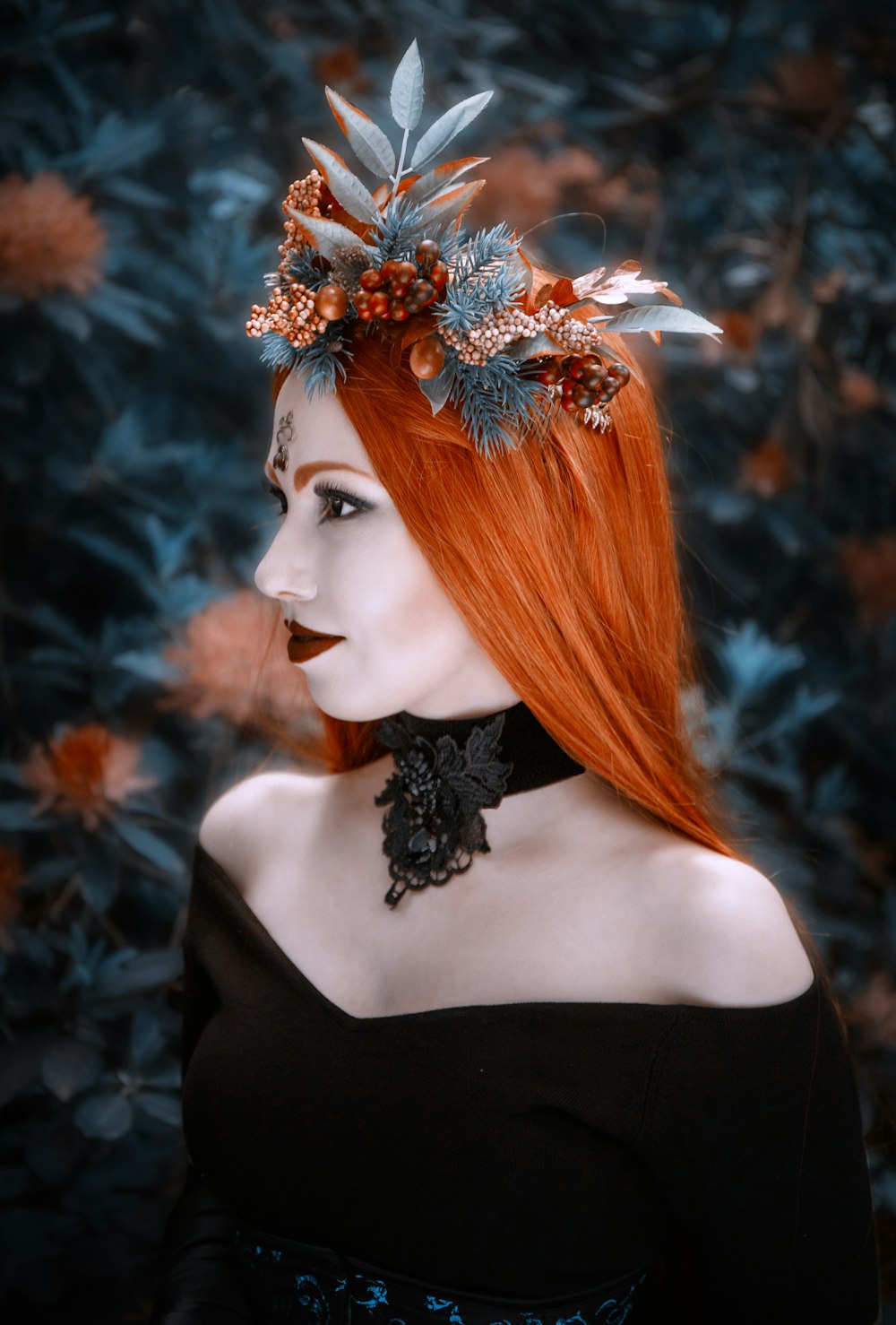 a woman with red hair wearing a black dress