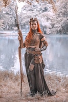 An adult model showcasing a detailed fantasy-themed outfit outdoors.