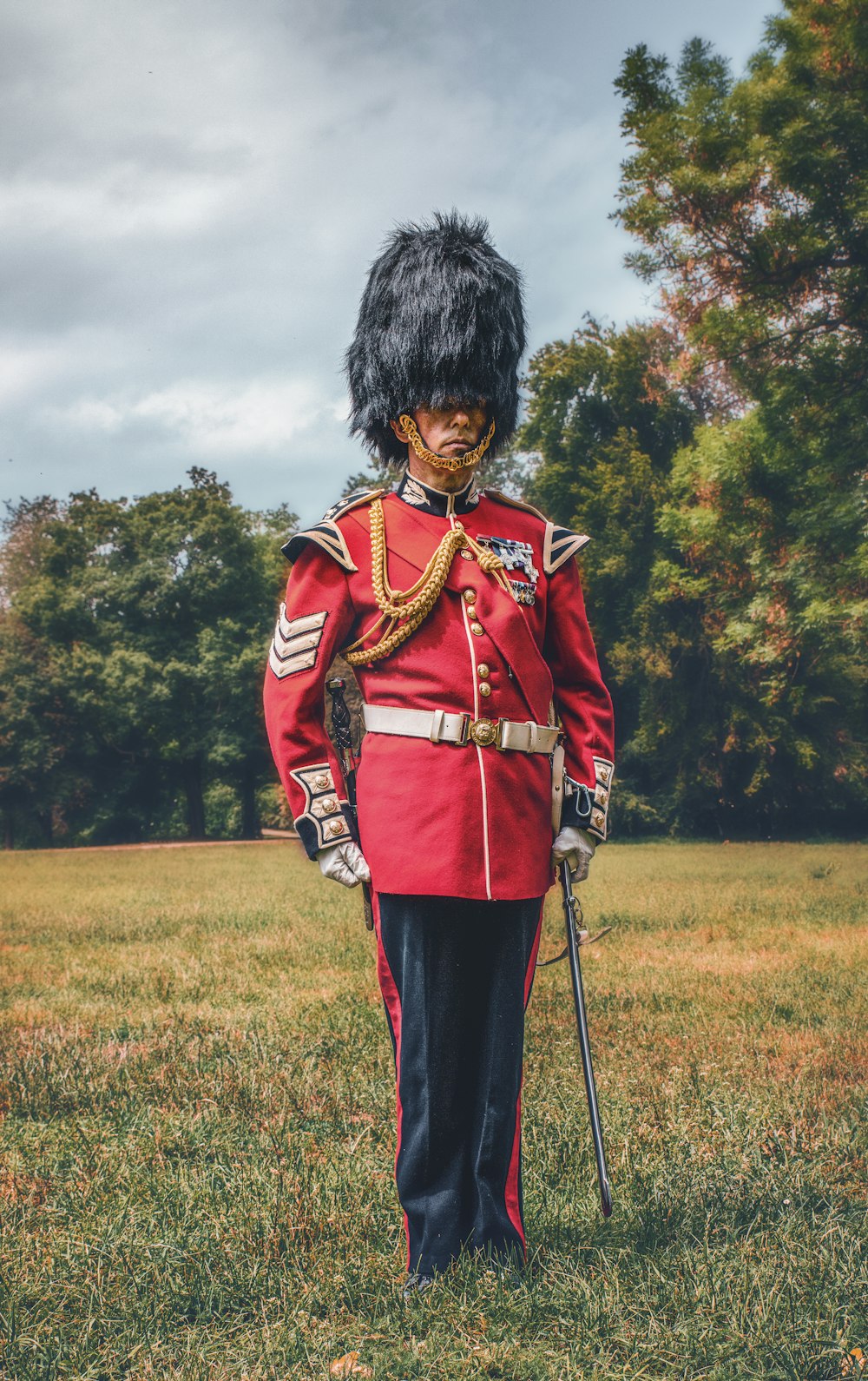 a man in a red uniform standing in a field