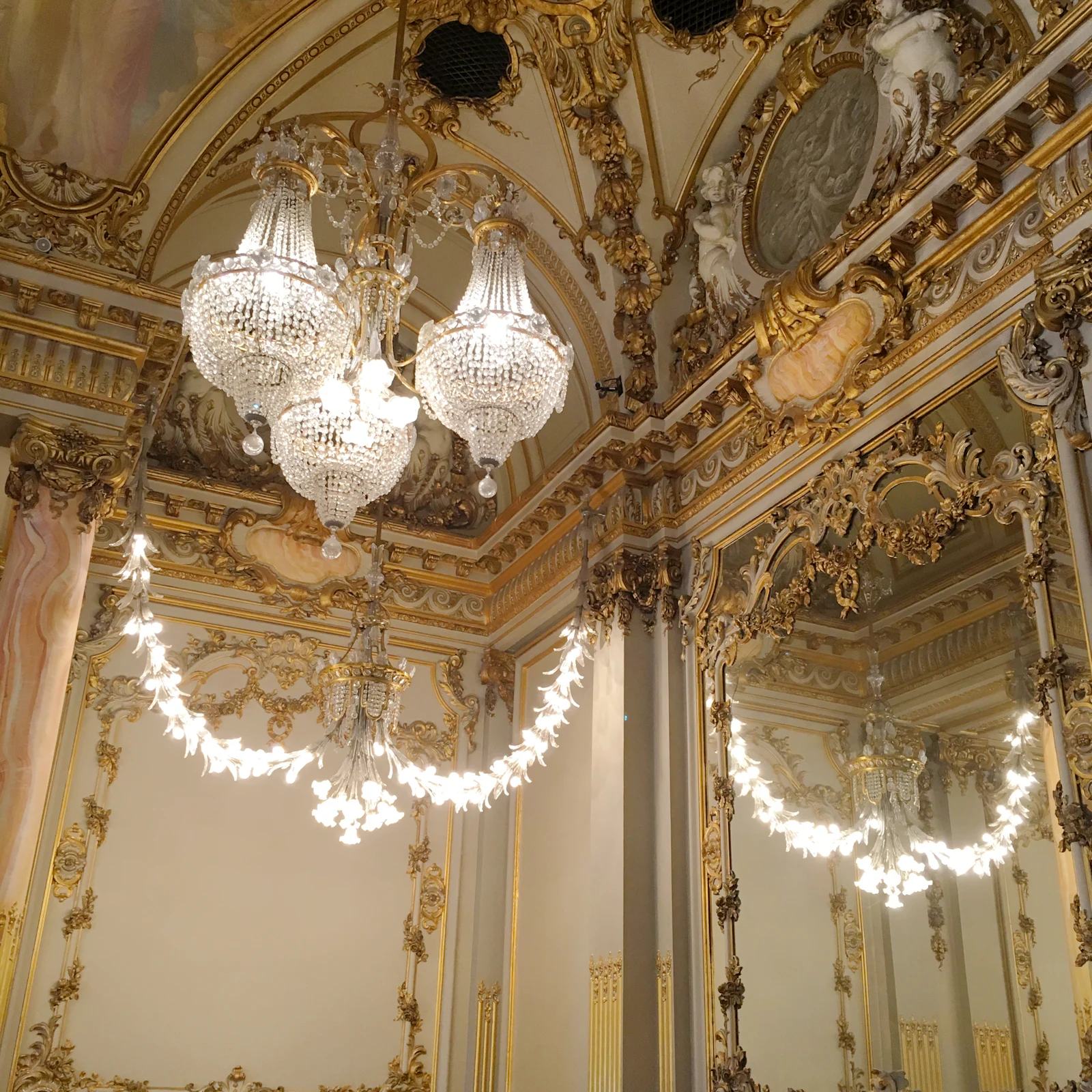 A crystal chandelier hanging from a high ceiling.