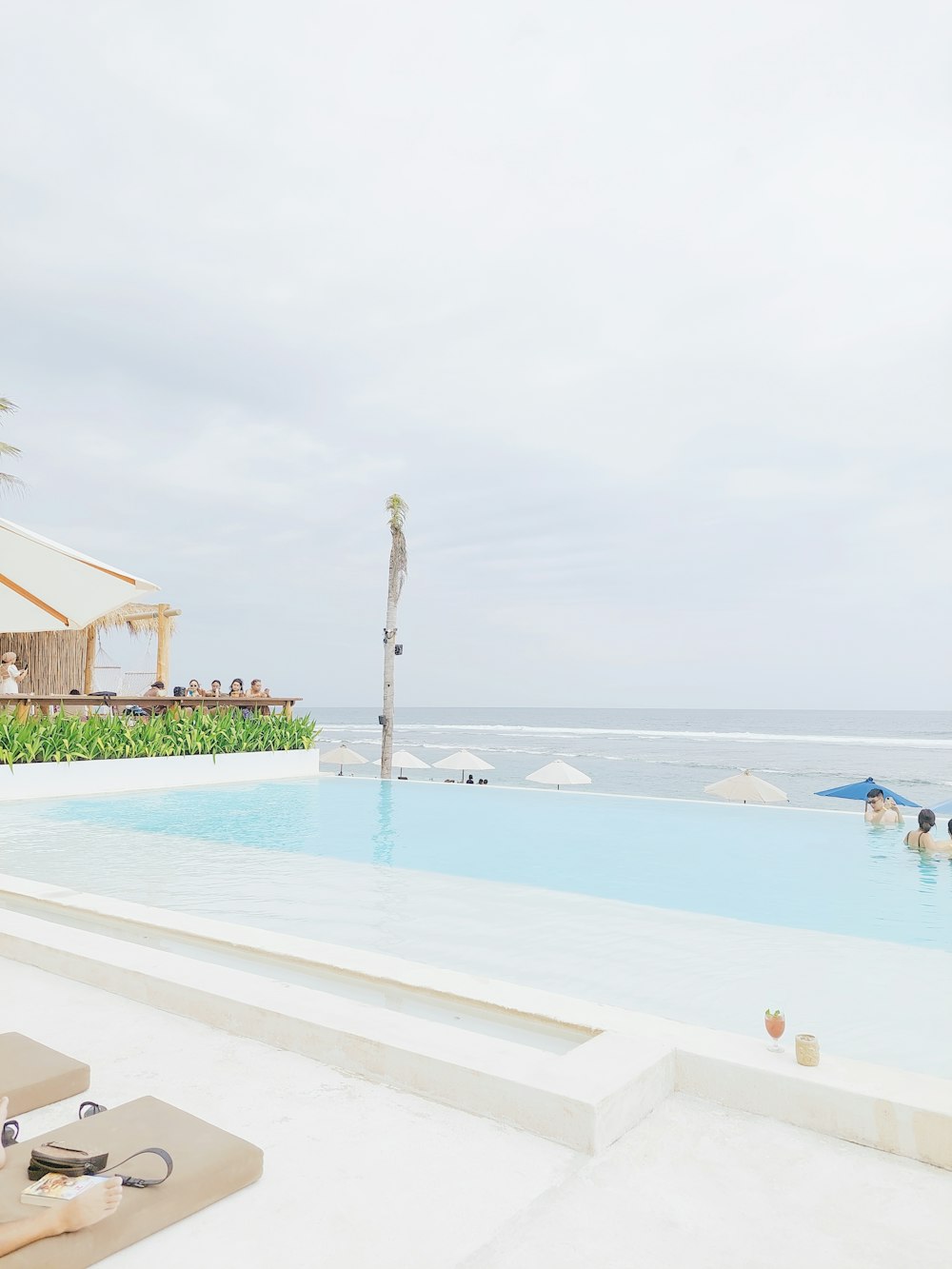 a large swimming pool next to a beach