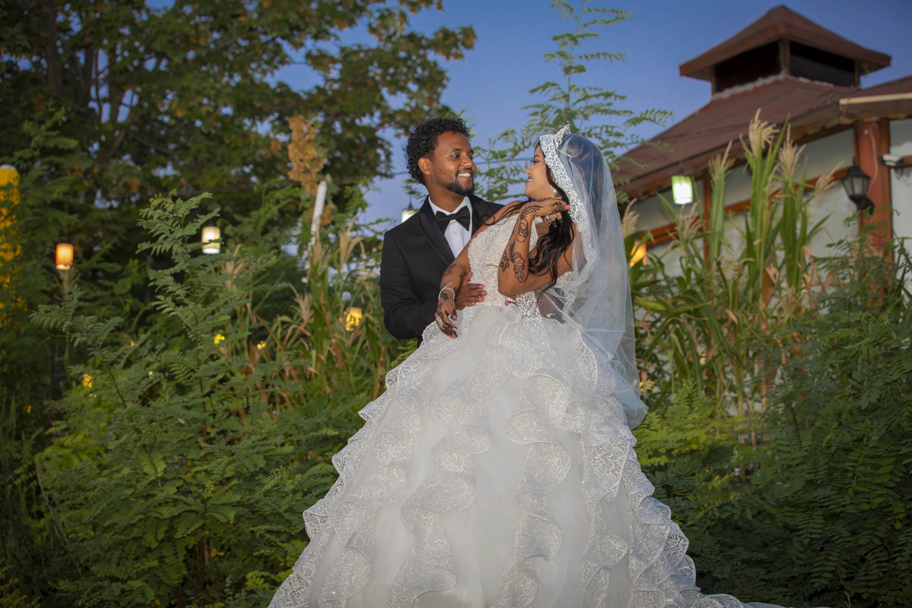 Bride and groom in a garden at golden hour