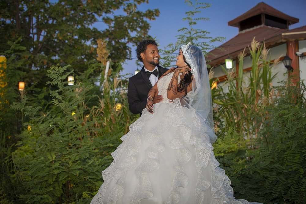 a bride and groom posing for a picture