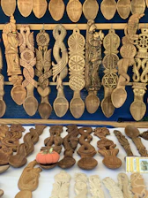 A vibrant display of various spoons and kitchen tools arranged artistically on a wooden table.