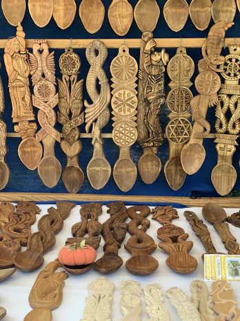A vibrant display of various spoons and kitchen tools arranged artistically on a wooden table.