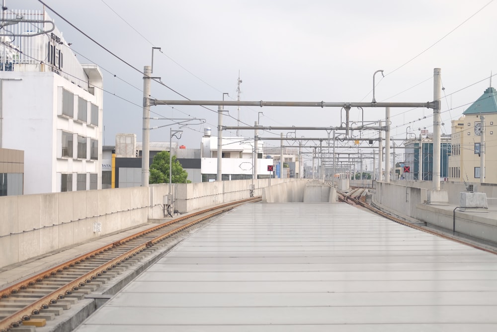 a train track with a building in the background