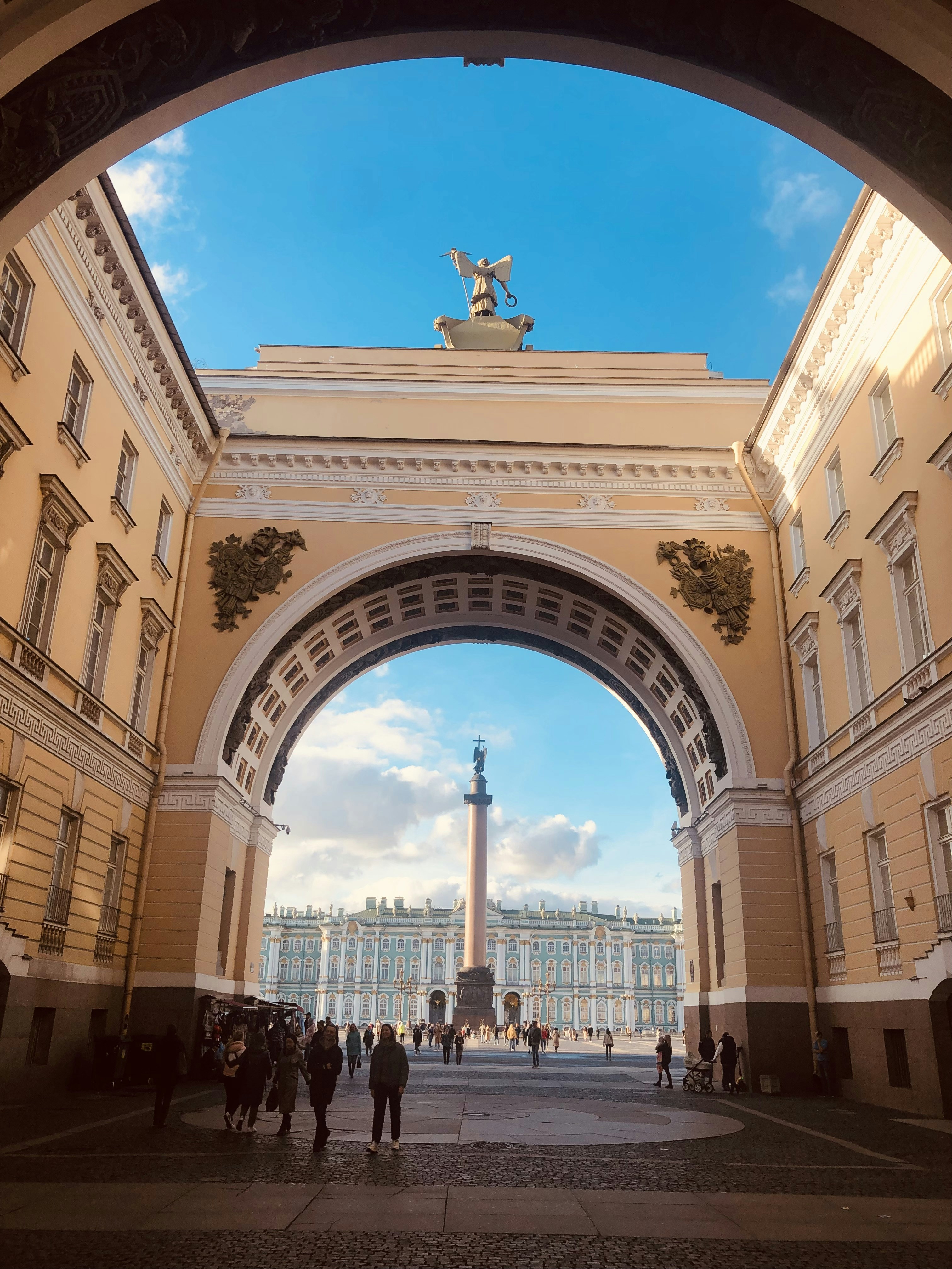 a group of people standing under an arch in a building