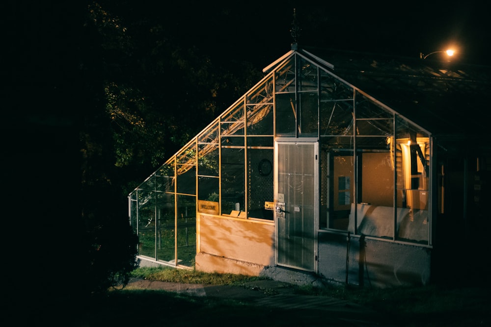 a house with a greenhouse in the middle of the night