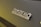 Close-up view of a 'Sanremo Coffee Machines' logo on a dark surface.