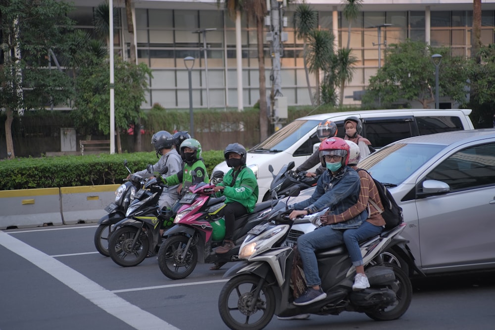 a group of people riding motorcycles down a street