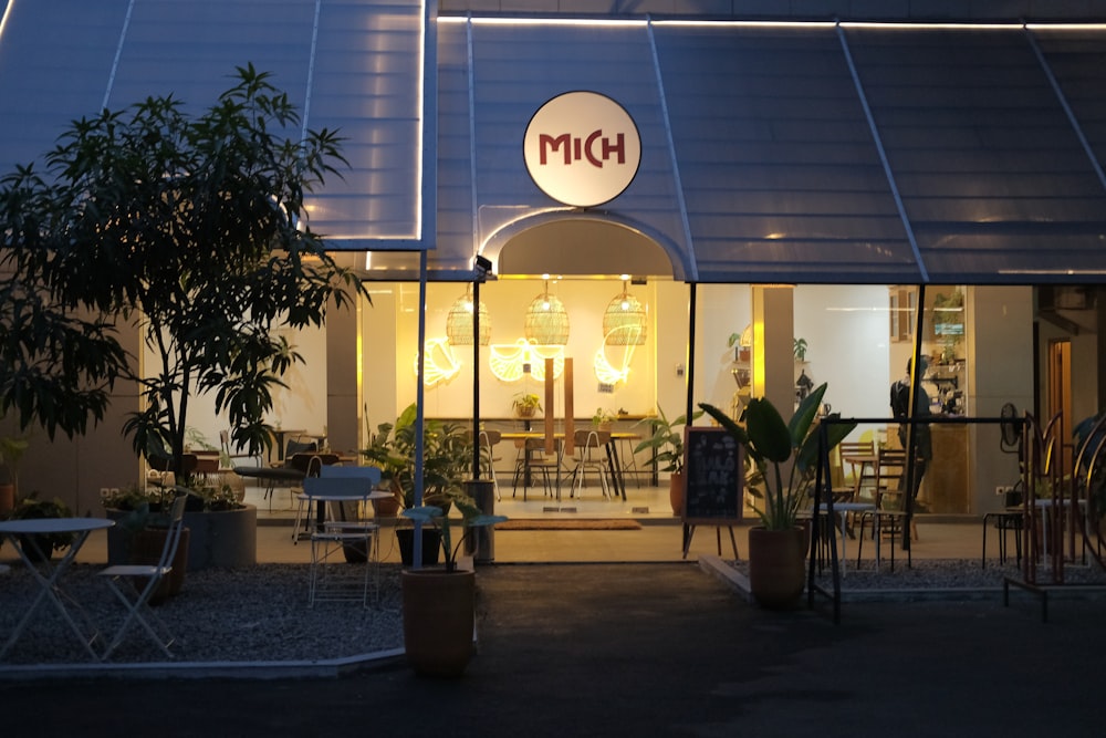 a store front at night with a lit up sign