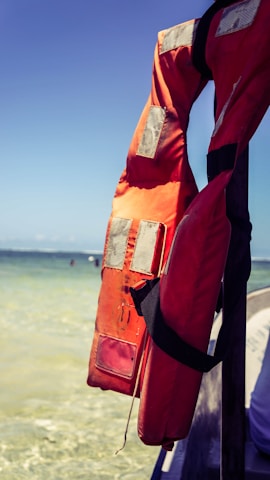 A customer fitting a high-quality life jacket on their boat at the marina.