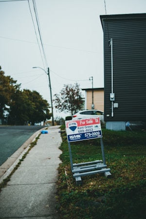 A residential for sale sign along a neighborhood street, the front end of the sales pipeline that later becomes a closing