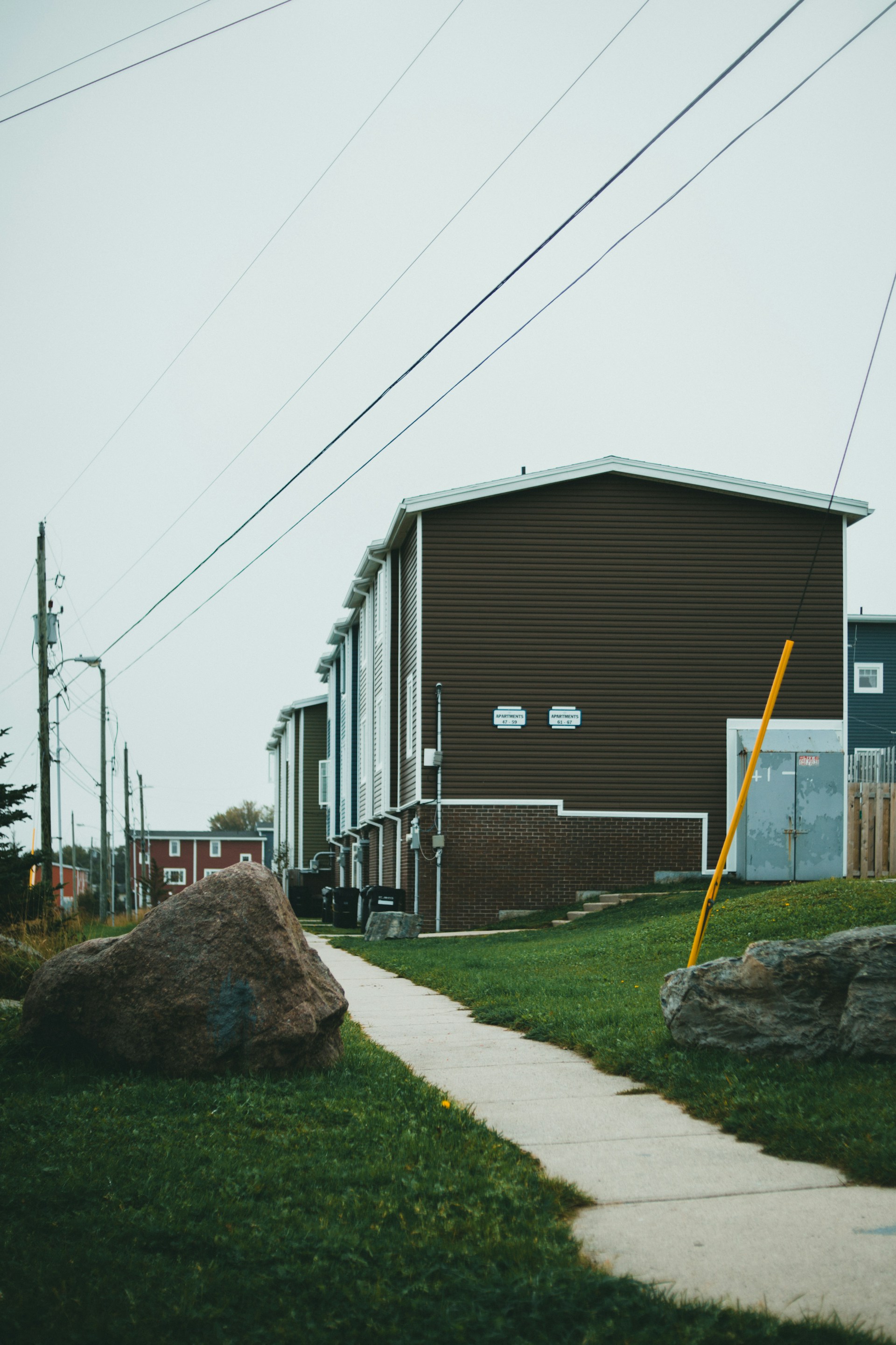 a brown building with a yellow pole in front of it