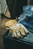 a pair of gloves sitting on top of a trash can