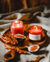 Richly scented gourmand candles displayed with fresh vanilla pods and cinnamon sticks