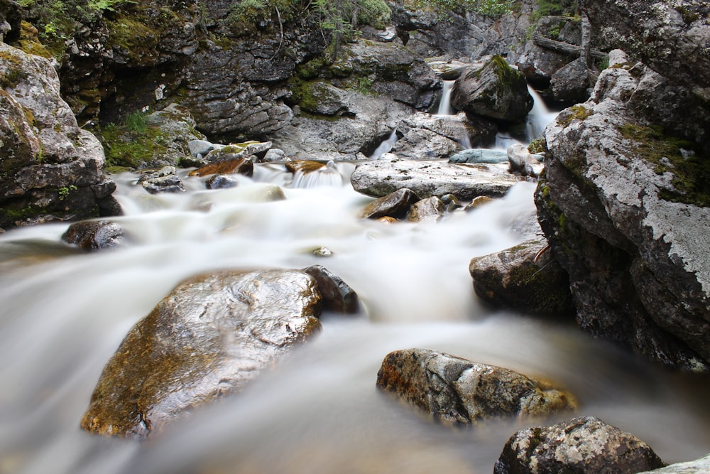 a stream of water running between some rocks