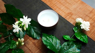 A small earthen bowl filled with cold-pressed sesame oil surrounded by sesame seeds on a beige linen cloth.