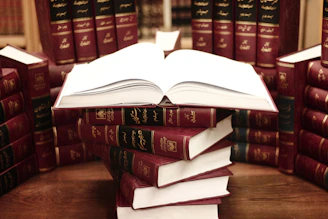 a stack of books sitting on top of a wooden table