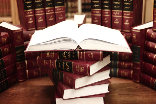 a stack of books sitting on top of a wooden table