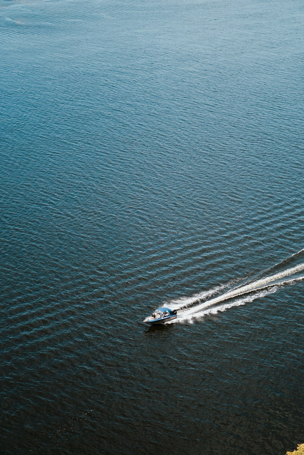 a small boat traveling across a large body of water