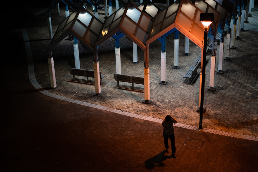 a person standing in front of a row of benches