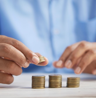 a person stacking coins on top of a table