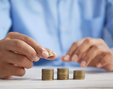 a person stacking coins on top of a table