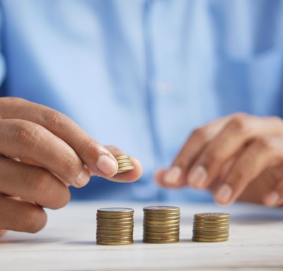 a person stacking coins on top of a table