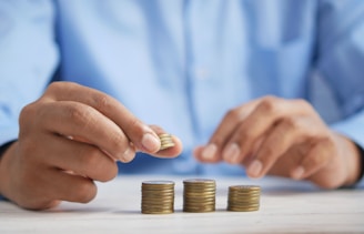 a person stacking coins on top of a table