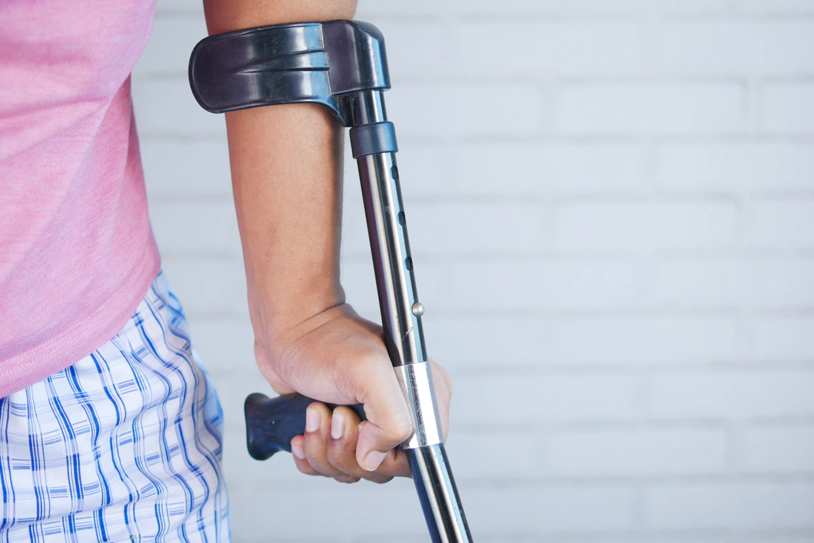 Person holding crutches during recovery