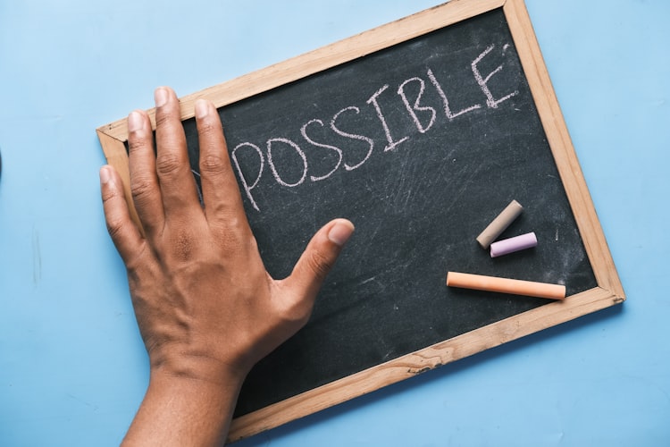 A chalk board that says possible