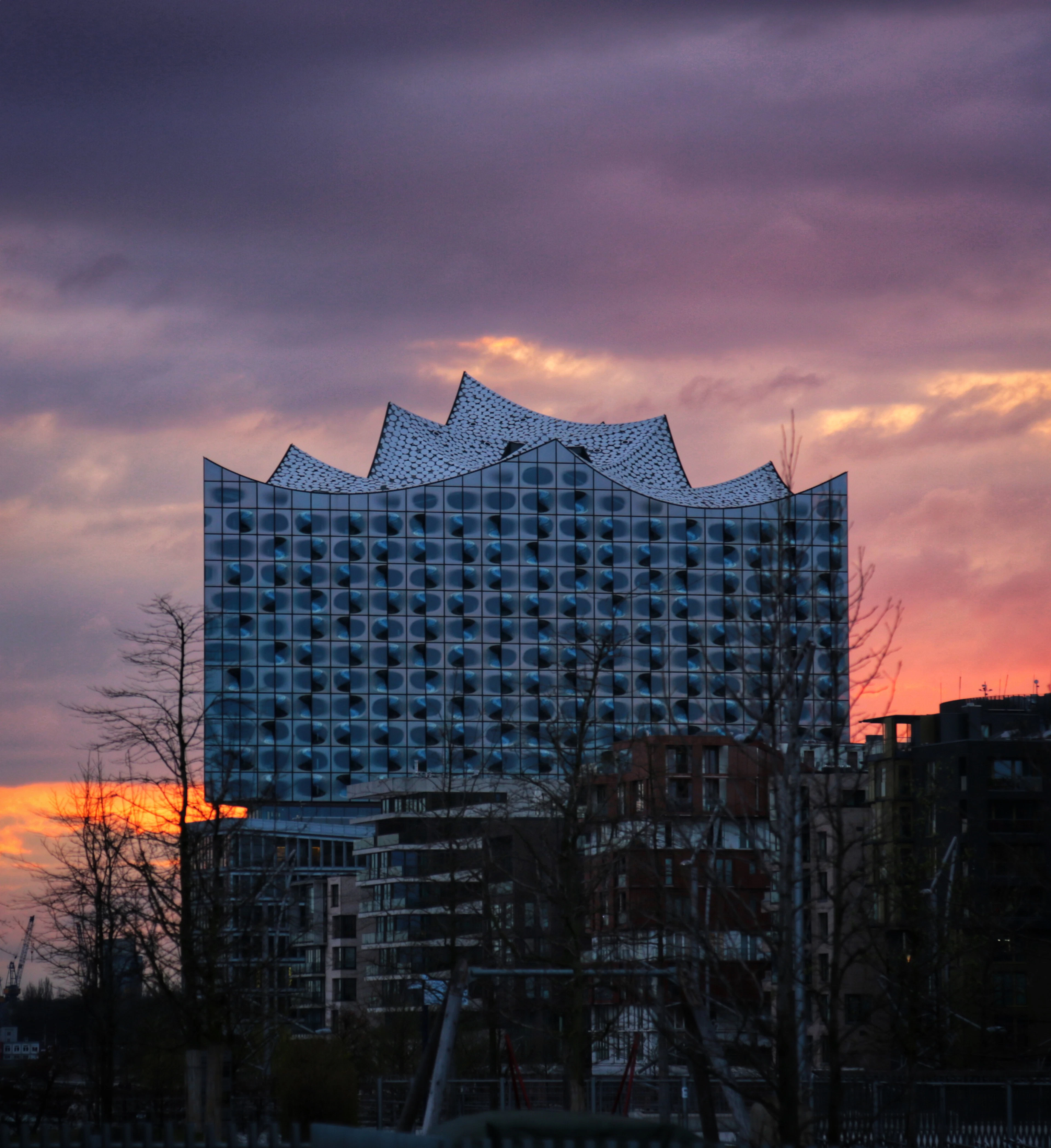 The wave-shaped glass crown of the Elbphilharmonie concert hall at sunset, Hamburg