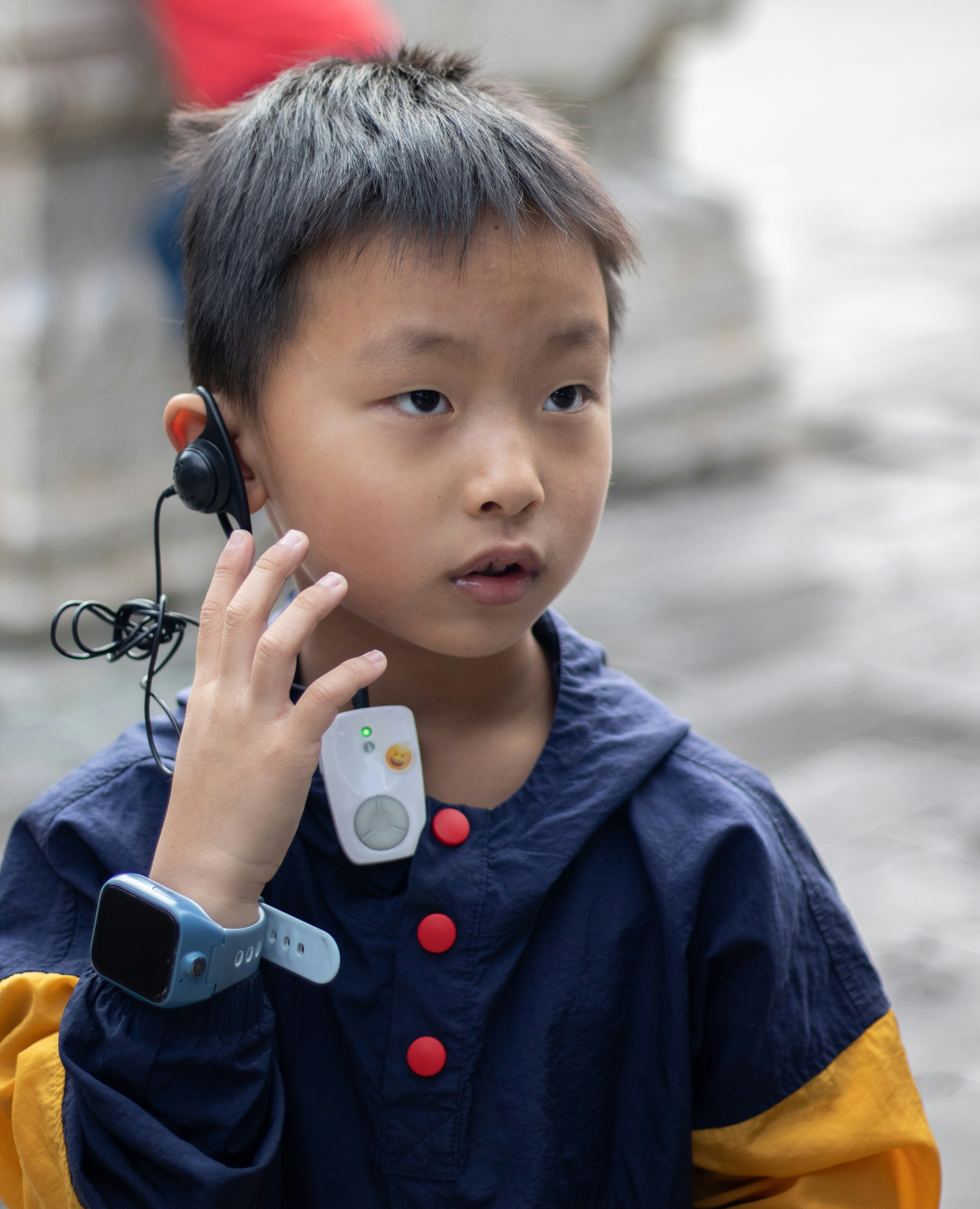 a young boy wearing a headset while talking on a cell phone