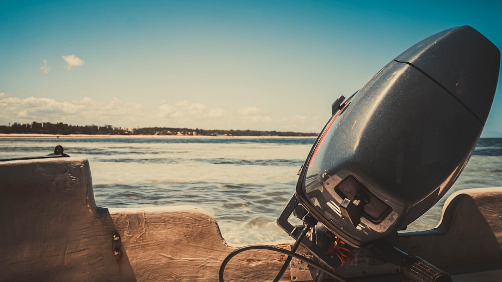 a boat sitting on top of a wooden dock next to the ocean