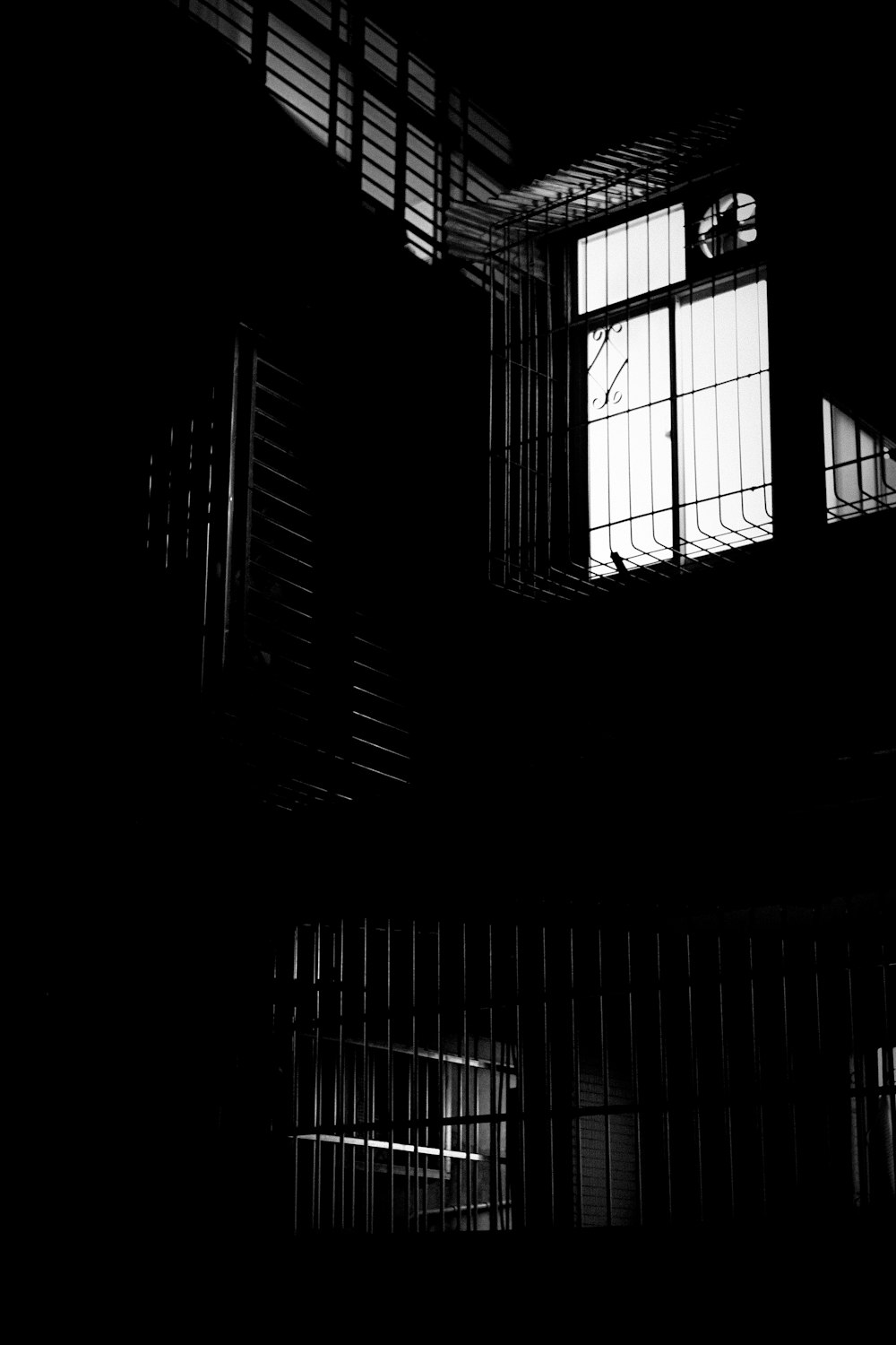 a black and white photo of a jail cell