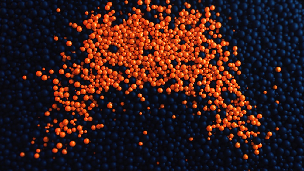 a lot of orange balls sitting on top of a blue surface