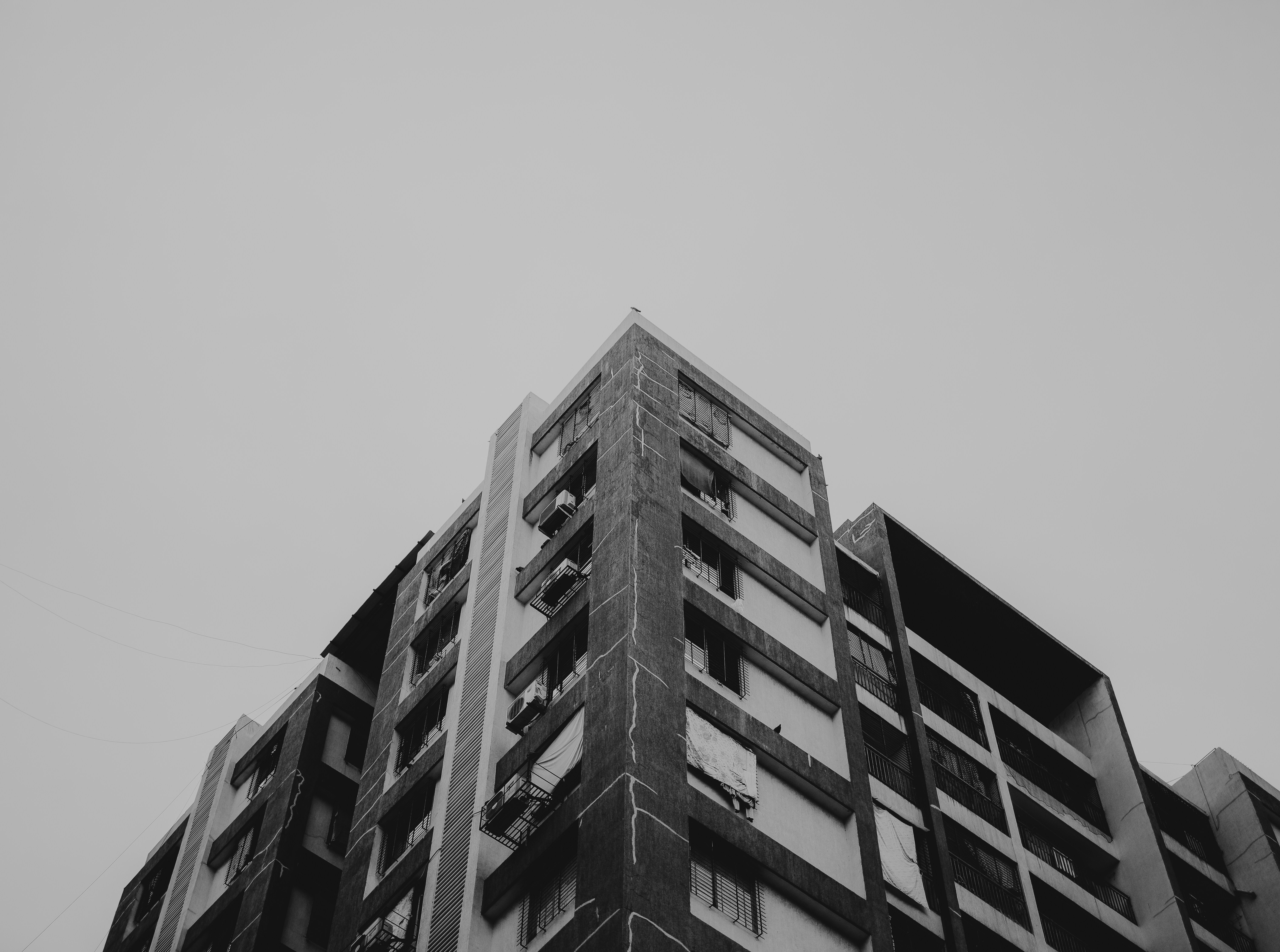 A black and white photo of a tall building photo Free Wallpaper Image