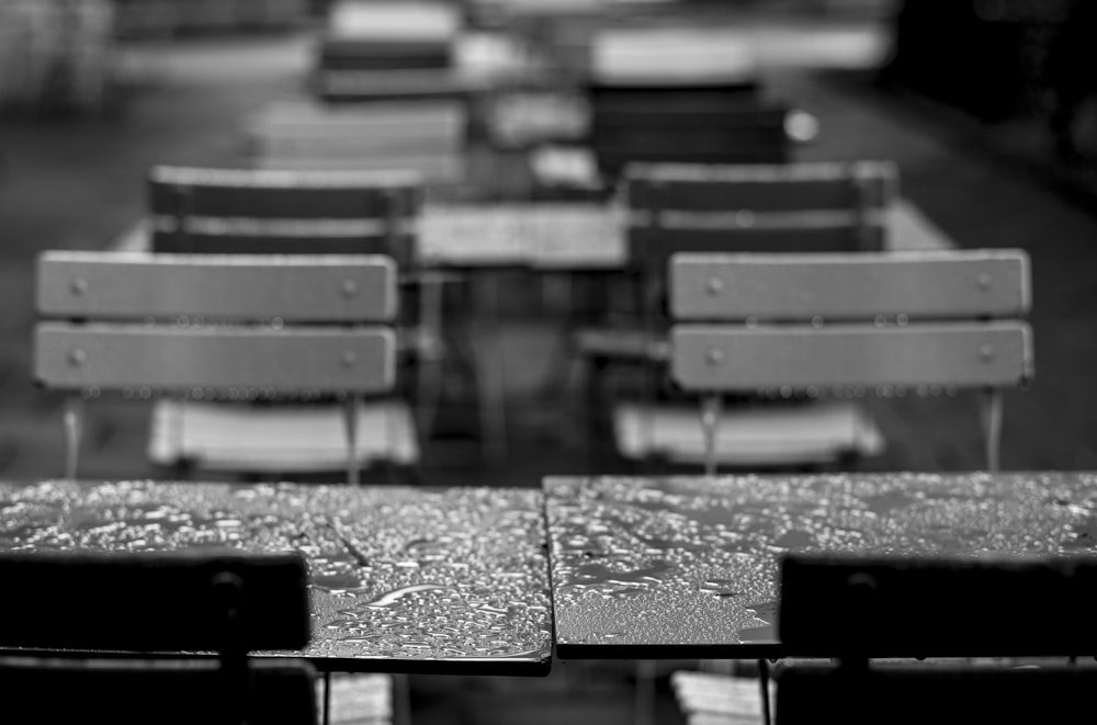 a black and white photo of a row of benches