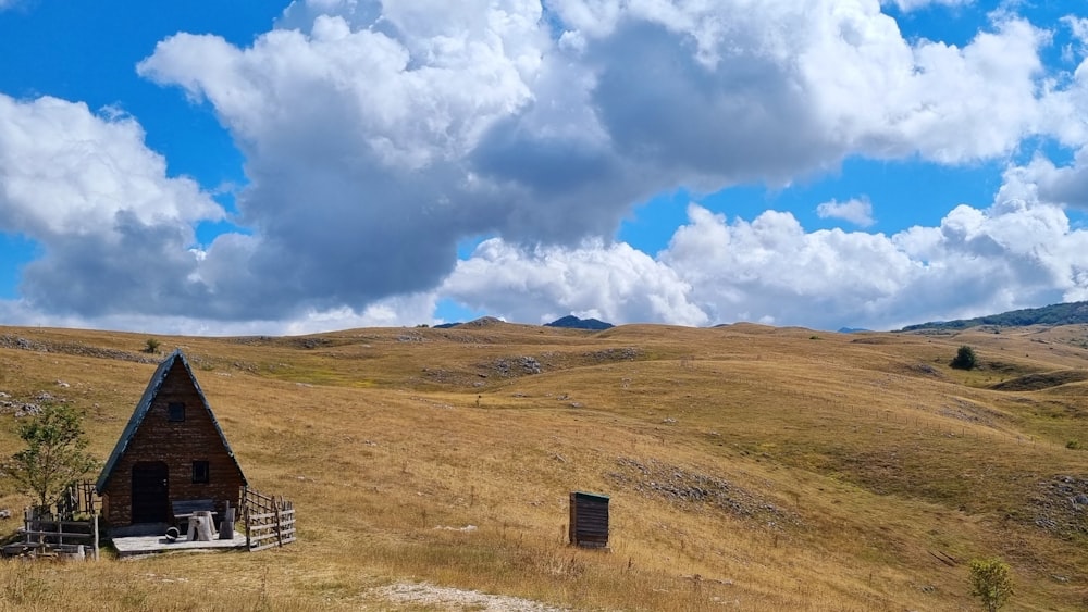 a small cabin in the middle of a field