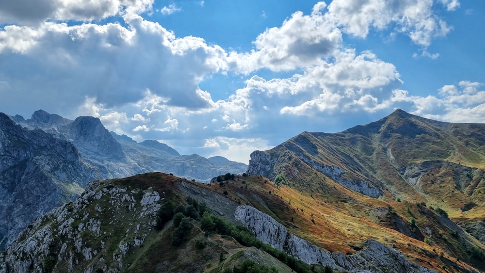 a view of a mountain range with clouds in the sky