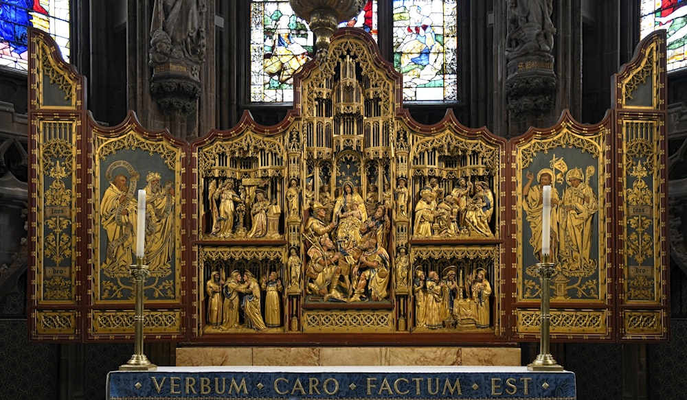 a very ornate alter in a church with stained glass windows