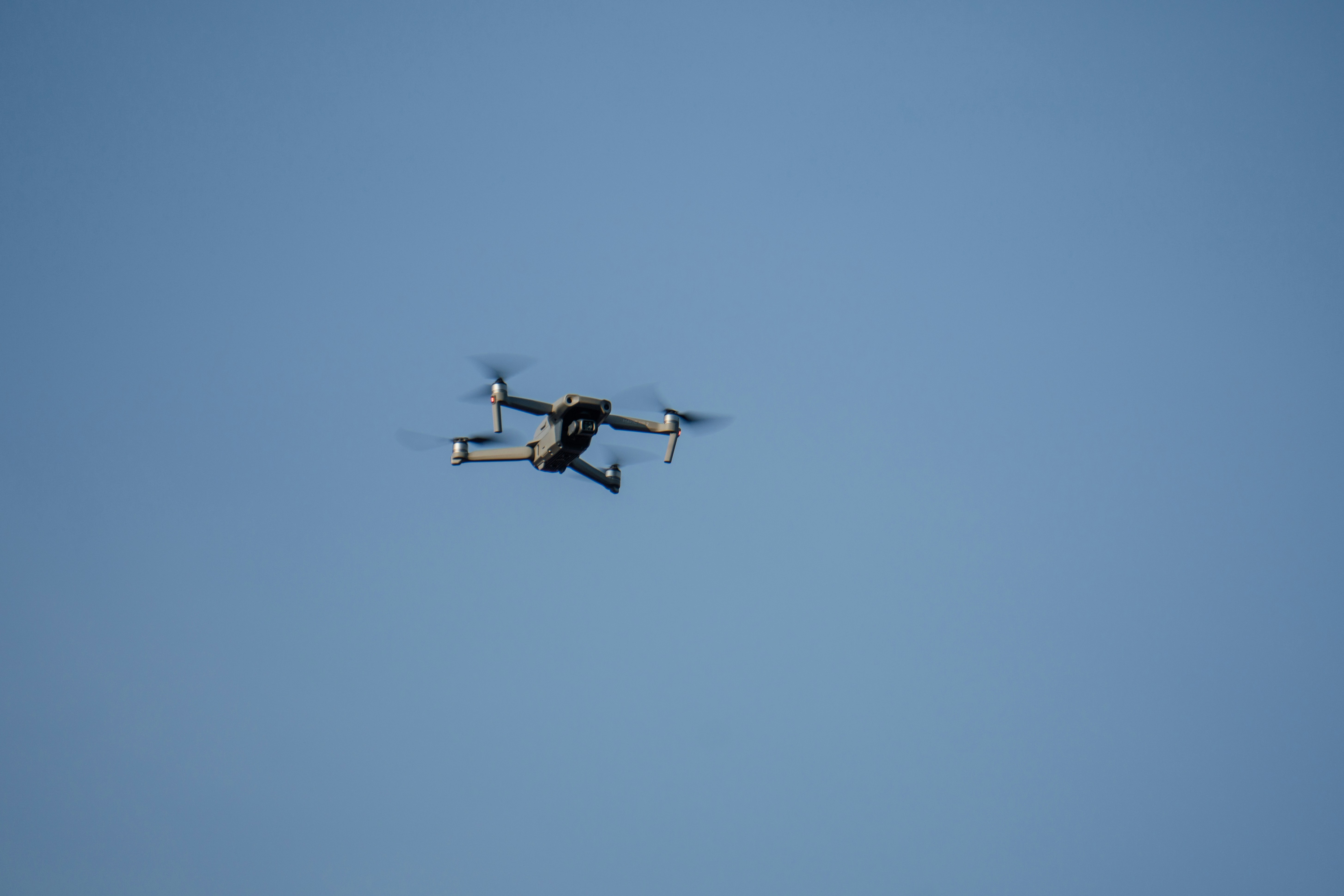a small plane flying through a blue sky