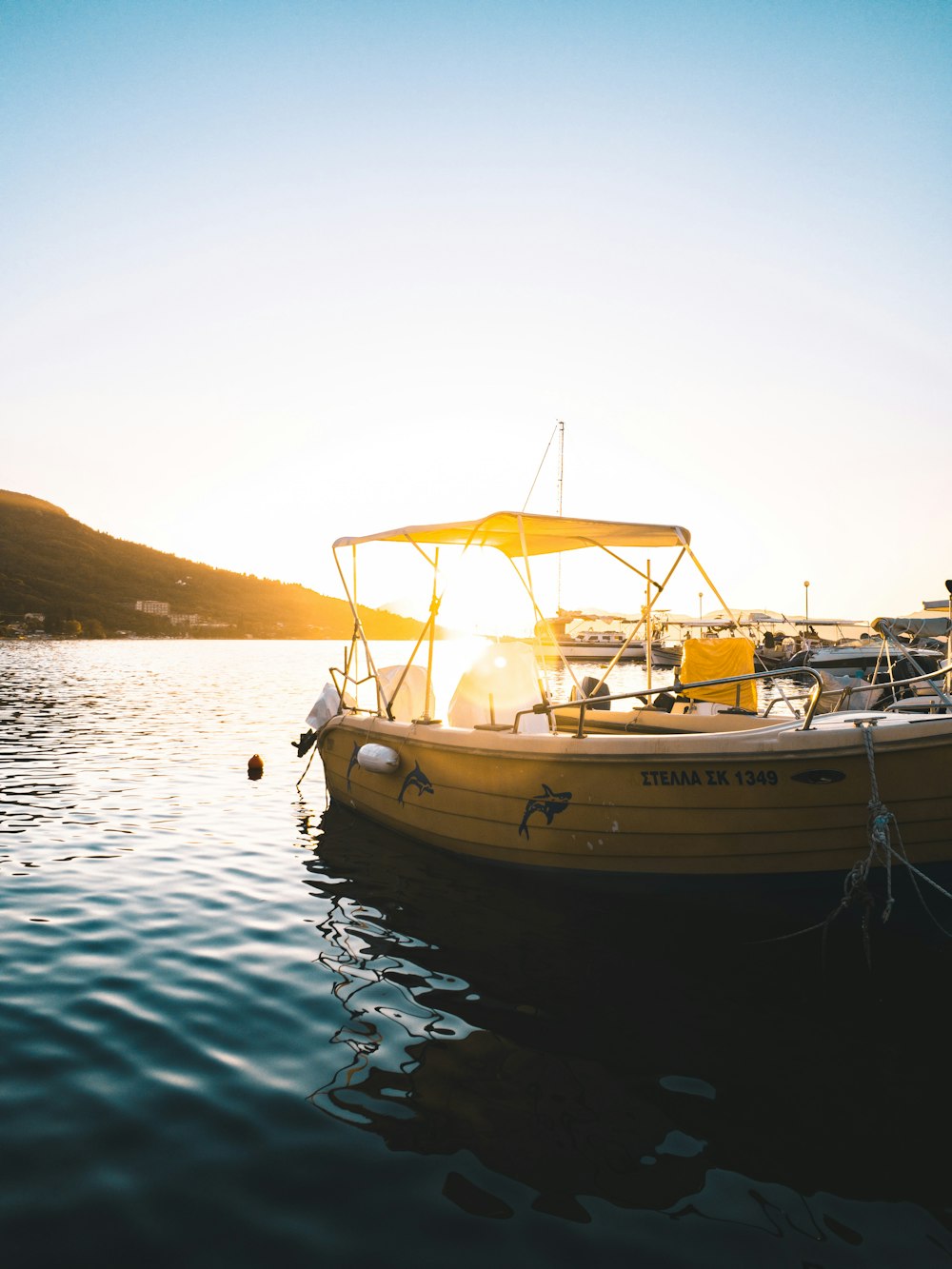 a yellow boat floating on top of a body of water