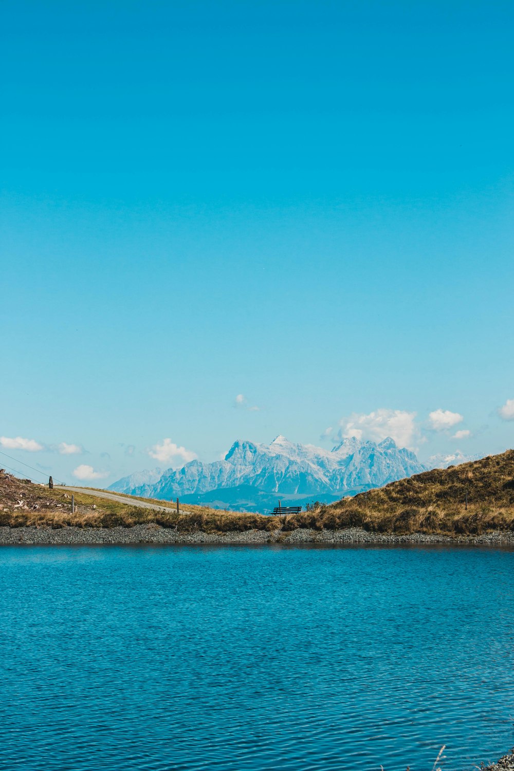 a body of water with mountains in the background