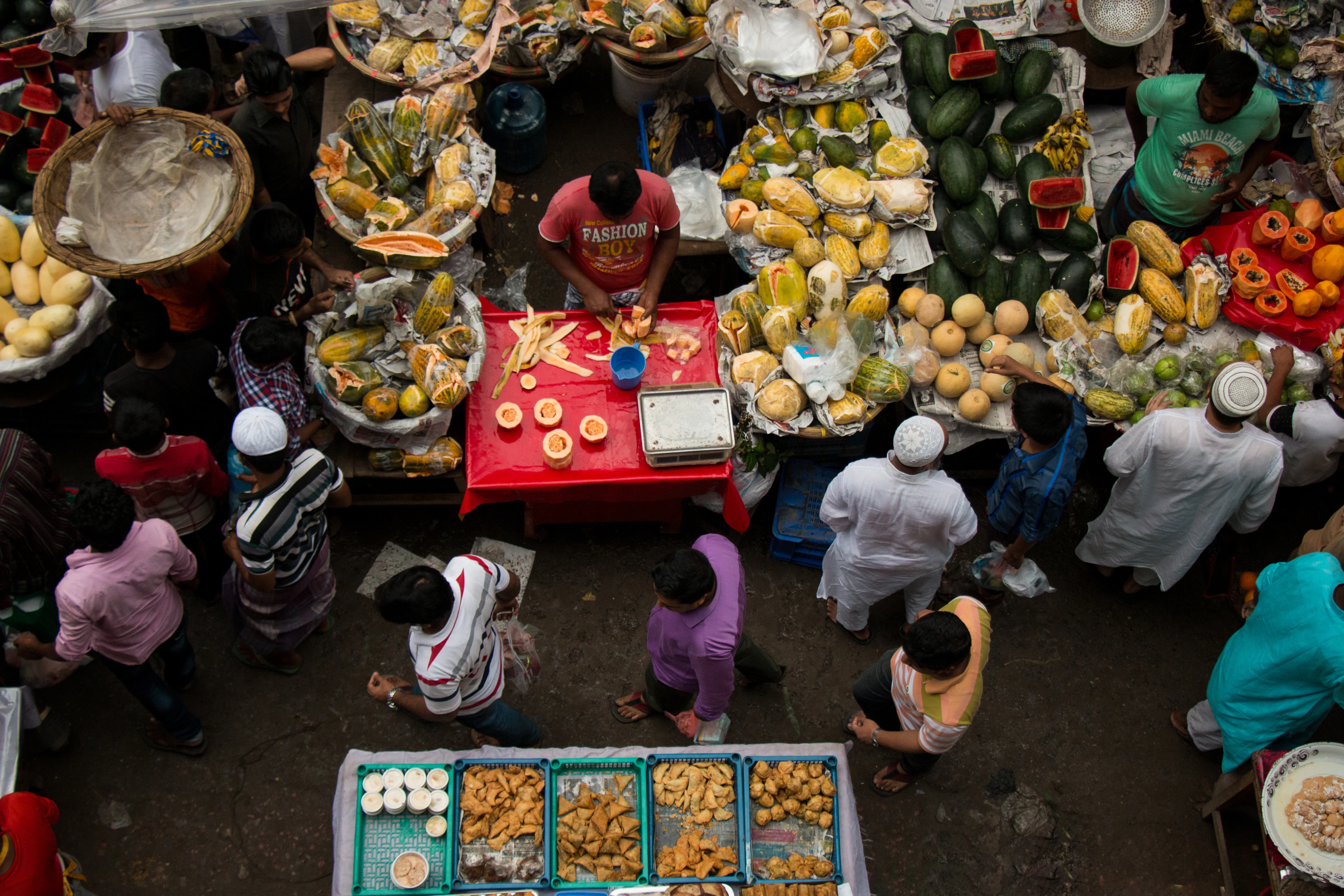 A market in Fez seen from above, produce stalls and shoppers filling the lane