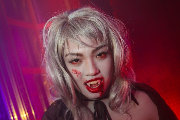 a woman dressed as a zombie in a dark room
